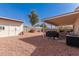 Spacious backyard featuring a covered patio, storage shed, and low-maintenance gravel landscaping at 2177 S Weaver Dr, Apache Junction, AZ 85120