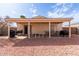 Inviting backyard with covered patio, ideal for outdoor dining and relaxation with easy-care gravel landscape at 2177 S Weaver Dr, Apache Junction, AZ 85120