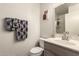 Well-lit bathroom featuring a toilet, sink, and decorative mirror at 2177 S Weaver Dr, Apache Junction, AZ 85120