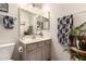 Bright bathroom featuring a toilet, sink, and decorative mirror at 2177 S Weaver Dr, Apache Junction, AZ 85120