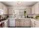 Bright kitchen with a window over the sink, granite countertops, and wooden cabinets at 2177 S Weaver Dr, Apache Junction, AZ 85120