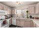 Bright kitchen with a window over the sink, granite countertops, and wooden cabinets at 2177 S Weaver Dr, Apache Junction, AZ 85120