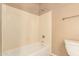 Bathroom featuring a tub with shower head and a toilet at 22139 N 80Th Ln, Peoria, AZ 85383