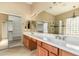 Bathroom featuring a double vanity with spacious countertop and a large mirror at 22139 N 80Th Ln, Peoria, AZ 85383