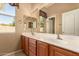 Bathroom with a double sink vanity, decorative mirror and lighting at 22139 N 80Th Ln, Peoria, AZ 85383