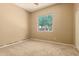 Neutral bedroom features carpet and a window overlooking green space at 22139 N 80Th Ln, Peoria, AZ 85383