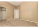 Bedroom featuring neutral carpet, ceiling fan, and closet at 22139 N 80Th Ln, Peoria, AZ 85383