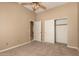 Carpeted bedroom with doors to the bathroom and walk-in closet at 22139 N 80Th Ln, Peoria, AZ 85383