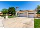 Front view of the 3-car garage and driveway of this single-Gathering home at 22139 N 80Th Ln, Peoria, AZ 85383