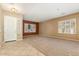 Spacious living room with tile entry, carpeted area, and plantation shutters at 22139 N 80Th Ln, Peoria, AZ 85383