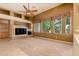 Cozy living area with built in fireplace, shelving, and media niche and large windows at 22139 N 80Th Ln, Peoria, AZ 85383