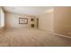 Open living room with carpet flooring and view of hall with arched doorway at 22139 N 80Th Ln, Peoria, AZ 85383