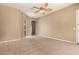 Neutral living room with an archway view of the bathroom and carpet flooring at 22139 N 80Th Ln, Peoria, AZ 85383