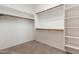 Walk-in closet with built-in shelving and wood rods, providing ample storage space at 22139 N 80Th Ln, Peoria, AZ 85383