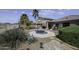 Beautiful backyard featuring a spa, mature landscaping, and comfortable outdoor seating area at 22346 N Goles Dr, Maricopa, AZ 85138