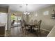 Charming dining area with a wooden table set, tile floors, and sliding glass doors to patio at 22346 N Goles Dr, Maricopa, AZ 85138