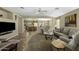 Bright and open living room featuring tile flooring and a view into the kitchen at 22346 N Goles Dr, Maricopa, AZ 85138