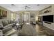 Comfortable living room featuring a stone fireplace, tile flooring, and neutral paint colors at 22346 N Goles Dr, Maricopa, AZ 85138