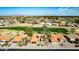 Expansive aerial view showcases community homes nestled amidst lush greenery and a golf course at 2415 Leisure World --, Mesa, AZ 85206