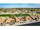 Expansive aerial view showcases community homes nestled amidst lush greenery and a golf course at 2415 Leisure World --, Mesa, AZ 85206