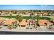 Bird's-eye view of a desert community with a golf course and mountains in the distance at 2415 Leisure World --, Mesa, AZ 85206