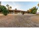 View of the home's covered backyard patio and landscaping with golf course view at 2415 Leisure World --, Mesa, AZ 85206