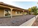 Backyard patio with ceiling fans and desert landscaping overlooking a spacious green space at 2415 Leisure World --, Mesa, AZ 85206