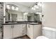 Bathroom with double sinks, a big mirror and white cabinets at 2415 Leisure World --, Mesa, AZ 85206