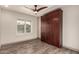 Bright bedroom featuring a wood Murphy bed, plank flooring, and window with shutter at 2415 Leisure World --, Mesa, AZ 85206