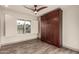 Bright bedroom featuring a wood Murphy bed, plank flooring, and window with shutter at 2415 Leisure World --, Mesa, AZ 85206