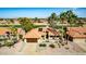 Attractive single-story home featuring a tile roof, desert landscaping, and solar panels on the roof at 2415 Leisure World --, Mesa, AZ 85206