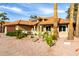 Single story tan home featuring desert landscaping, red gravel, palm trees, and a red tile roof at 2415 Leisure World --, Mesa, AZ 85206