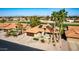 Aerial view of a charming home with a red tile roof, solar panels, and beautiful landscaping at 2415 Leisure World --, Mesa, AZ 85206