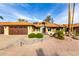 Charming single-story home featuring a desert landscape, tile roof, and an attached two-car garage at 2415 Leisure World --, Mesa, AZ 85206