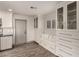 Built-in cabinetry with display shelving surrounds a window seat in the home's bright kitchen at 2415 Leisure World --, Mesa, AZ 85206