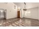 Spacious living room featuring tile floors, a decorative light fixture, and a wooden front door at 2415 Leisure World --, Mesa, AZ 85206