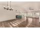 Open-concept living space with vaulted ceilings flowing into a modern kitchen with a statement island at 2415 Leisure World --, Mesa, AZ 85206