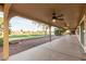 Covered patio overlooking the golf course with ceiling fans and desert landscaping at 2415 Leisure World --, Mesa, AZ 85206