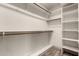 White walk-in closet with ample shelving and wood-look flooring at 2415 Leisure World --, Mesa, AZ 85206