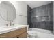 Updated bathroom with a modern vanity, oval mirror, and a tiled shower-tub combo at 25620 S Cloverland Dr, Sun Lakes, AZ 85248