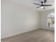 Large empty bedroom with wood-look floors and a large arched window with shutters at 25620 S Cloverland Dr, Sun Lakes, AZ 85248