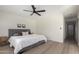 Bright bedroom featuring a ceiling fan, neutral decor, and wood-look floors at 25620 S Cloverland Dr, Sun Lakes, AZ 85248