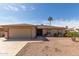 Inviting single-story home with a well-maintained yard and desert landscaping, showcasing curb appeal at 25620 S Cloverland Dr, Sun Lakes, AZ 85248