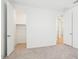 Bedroom with carpet, closet, and bright doorway at 2707 E Abe Truckle Ave, San Tan Valley, AZ 85140
