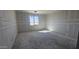 An unfinished bedroom with window allows for natural light, ready for personalization and customization at 2707 E Abe Truckle Ave, San Tan Valley, AZ 85140