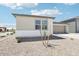Single-story home with a low-maintenance desert landscape and an attached two-car garage at 2707 E Abe Truckle Ave, San Tan Valley, AZ 85140