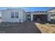 Exterior shot of home in progress, featuring a covered entry and garage with exposed wall construction at 2707 E Abe Truckle Ave, San Tan Valley, AZ 85140