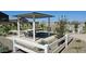 Shaded picnic area with tables and benches, enclosed by a white fence, providing a gathering spot at 2707 E Abe Truckle Ave, San Tan Valley, AZ 85140