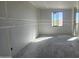 An unfinished room has a window offering natural light, prepped with drywall and ready for personalization at 2707 E Abe Truckle Ave, San Tan Valley, AZ 85140