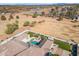 Home featuring a backyard pool, lush landscaping, and outdoor kitchen at 2838 E Vaughn Ct, Gilbert, AZ 85234